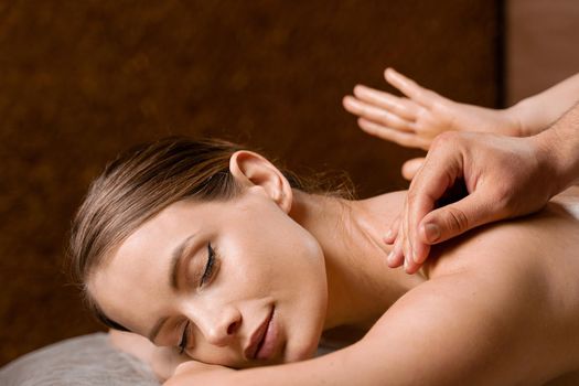 4 hands massage in spa. Two masseurs are making four hands relaxing massage with oil for girl. Relaxation. Manual therapy.