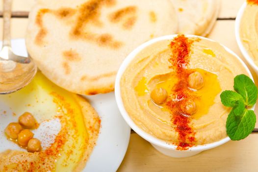 traditional chickpeas Hummus with pita bread and paprika on top 