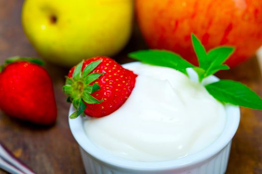 fresh fruits and whole milk yogurt on a rustic wood table