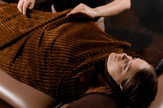 Full body wrap after chocolate massage. Beauty treatment for female model in spa