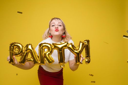 Fashionable womancelebrating a party event having fun and smiling with balloons