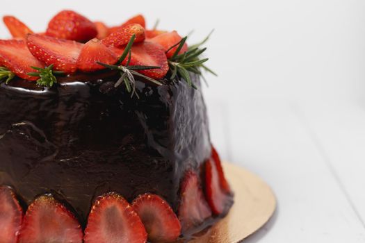 Delicious chocolate cake with strawberries on white background for food and bakery concept