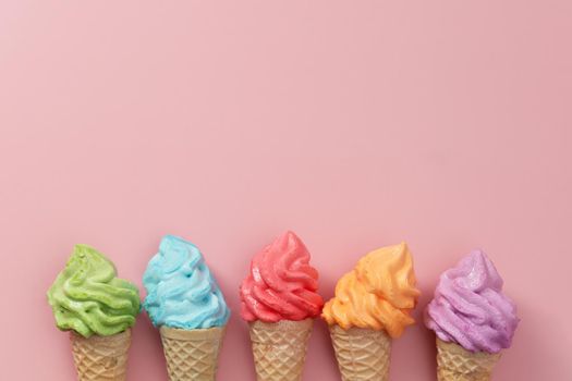 Various of colourful meringue ice cream cone on pink background for sweet and refreshing dessert concept