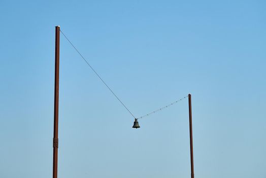 The art piece called Out of Tune by AK Dolven in Folkstone. A bell is hung on a piece of string between two poles.