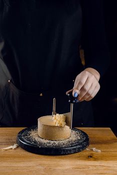 Shaving tete de moine cheese using girolle knife. Monks head. Variety of Swiss semi-hard cheese made from cows milk.