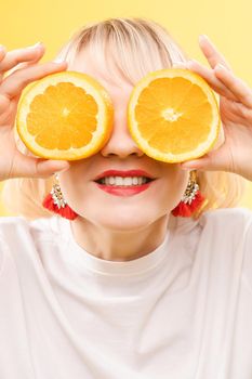 Portrait of a cool cheerful woman girl with oranges. Juice ads. Positive, harmony.