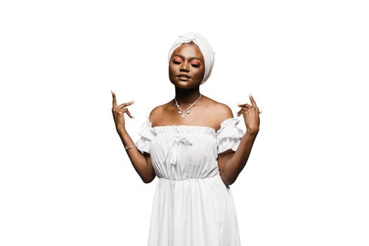 Beauty portrait of black attractive muslim model on white background. Relaxing and meditation