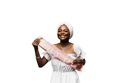 Happy muslim woman with birthday ribbon on white background. Black african woman is celebrating her birthday