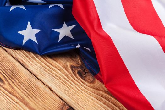 USA flag on light wooden table background close up copy space. creative photo.
