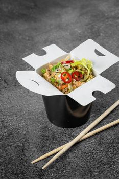 Rice in wok box for food delivery. Asian spicy dish for street restaurant and fast food cafe.