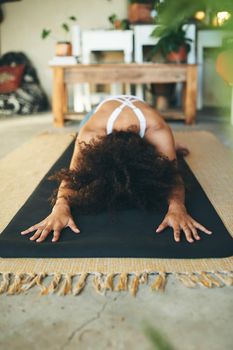 Closeup shot of an unrecognizable woman doing yoga in her Livingroom - Stock Photo