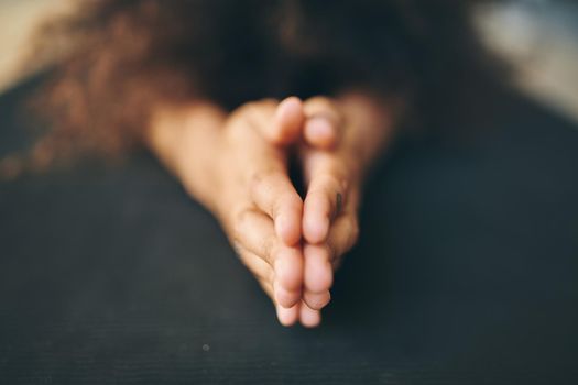 Closeup shot of an unrecognizable woman meditating at home - Stock Photo