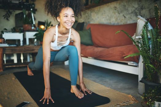 Shot of a young woman doing lunge exercise at home