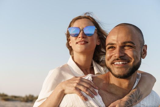 Young happy couple on seashore enjoying the sea, close up