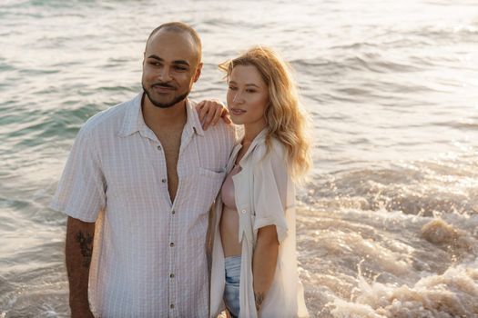 Young happy couple on seashore enjoying the sea, close up