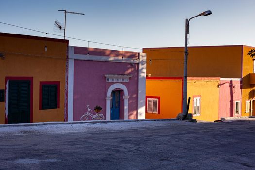 View of the typical Linosa house painted with yellow and red colors in the summer season. Linosa is one of the Pelagie Islands in the Sicily Channel of the Mediterranean Sea