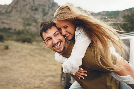 Happy loving couple hiking and hugging in mountains, close up