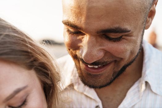 Close up photo portrait of smiling hugging couple