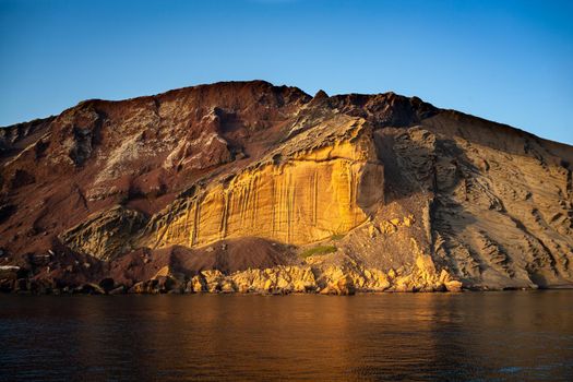 View of the Linosa volcano called Monte Nero in the beach of Cala Pozzolana di Ponente, Sicily