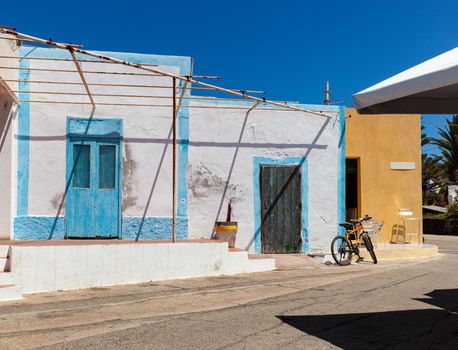 View of the typical Linosa house painted with white and blue colors in the summer season. Linosa is one of the Pelagie Islands in the Sicily Channel of the Mediterranean Sea