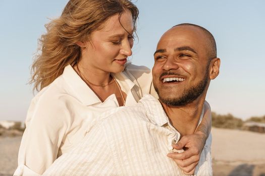 Young happy couple on seashore enjoying the sea, close up