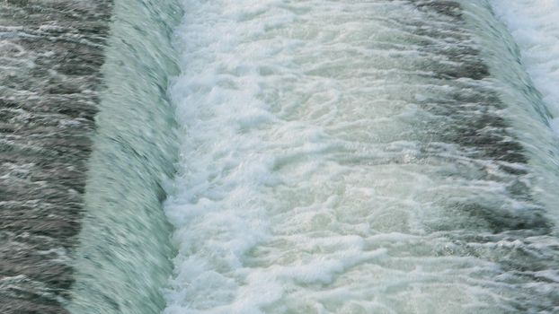 Water flowing quickly through a rapid cascade of River.