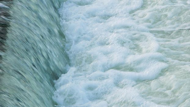 Water flowing quickly through a rapid cascade of River.