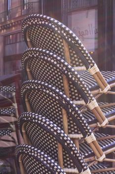 Stacked chairs in a street restaurant in Paris, France