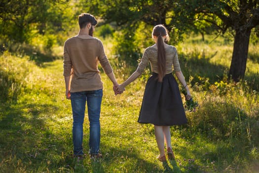 happy young couple walking in nature