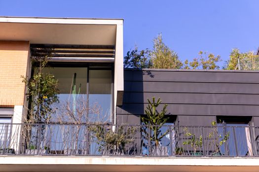 Parisian attic with panoramic windows and flowers in pots on the balcony on a sunny day