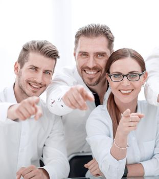 smiling business team pointing at you.the concept of choice