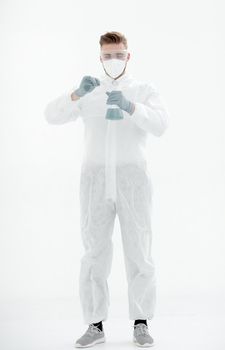 in full growth.a scientist in a protective suit examines the blue liquid.isolated on white