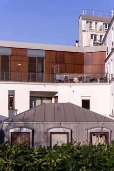 Parisian rooftops and balconies with greenery on a sunny day