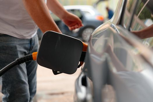 Hand Man Refill and filling Oil Gas Fuel at station. Gas station - refueling. To fill the machine with fuel. Car fill with gasoline at a gas station.