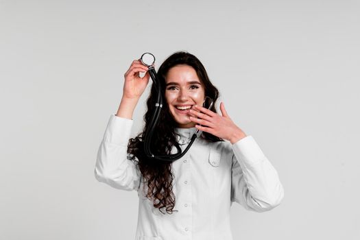 Doctor in medical robe with stethoscope at coronavirus covid-19 period. Nurse in white medical dress on white background