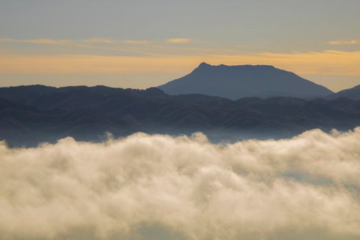 Landscape partially covered by a layer of fog under a blue sky in Tavertet town in Catalonia