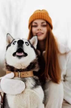 woman with a purebred dog winter landscape walk friendship winter holidays. High quality photo