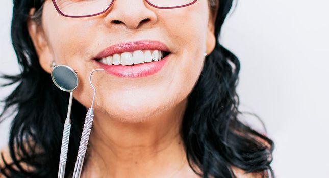 Close up of perfect smile and dentist tools on white background, Perfect smile of woman with dentist tools, Concept of perfect smile and dentist tools