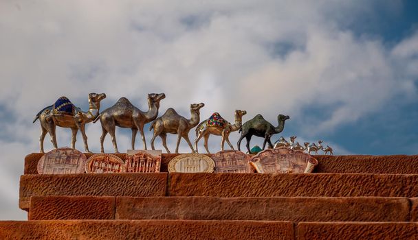 20 12 2020 Silver camels in Petra Jordan handmade by Bedouins to be sold in Petra to tourists set on red stone with sky background