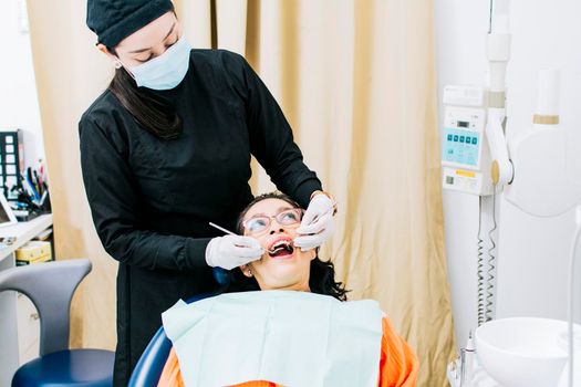 Dentist performing dental checkup, Patient checked by dentist, close up of dentist with patient, dentist performing root canal treatment on patient