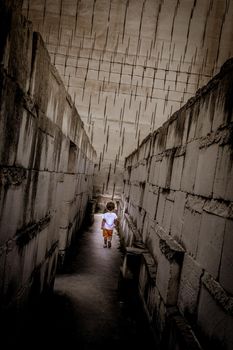 Caucasian young kid walking with labyrinth perspective. Conceptual image for dangerous situation during childhood.