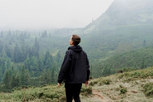 Hiking and climbing up to the top of the mountain. Men tourist is travelling and standing at the root of the mountain and watching to the peak.