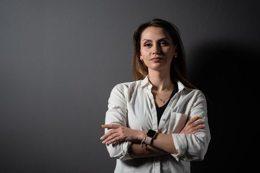 Business woman portrait on black background. Confident model posing. Lifestyle