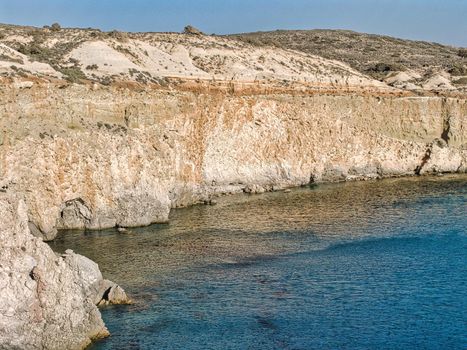 View to the rock formations of the famous Tsigrado on the cycladic island of Milos, Greece, with turquoise sea and moonscape coastline