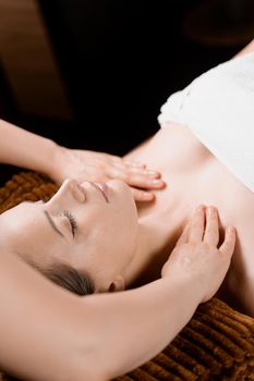 Neck and face massage in the spa. Beauty treatments for an attractive female model. Relaxation