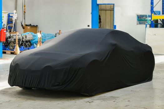New covered car model at the factory before the presentation