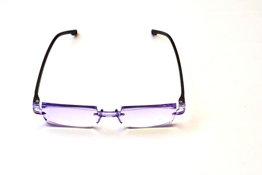 a pair of lenses set in a frame resting on the nose and ears, used to correct or assist defective eyesight or protect the eyes.