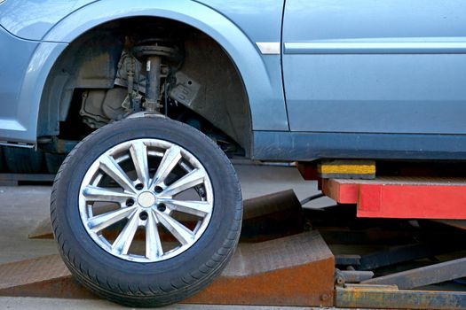 Replacing a car wheel at a tire station. a rubber covering, typically inflated or surrounding an inflated inner tube, placed around a wheel to form a flexible contact with the road.