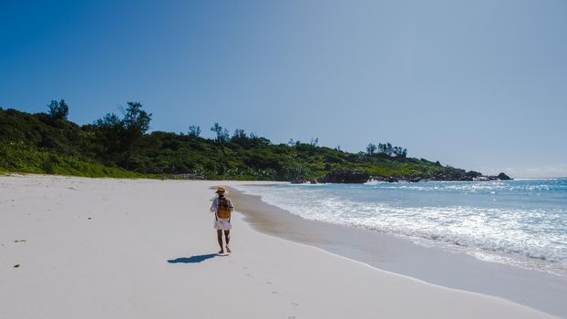 Anse Cocos beach, La Digue Island, Seyshelles, woman on vacation Seychelles. young Asian girl on the beach