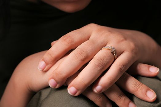 Close up of women hand with wedding ring .